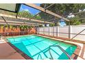 Refreshing pool with brick coping and screened enclosure at 519 Bradenton Rd, Venice, FL 34293