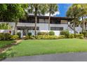 Two-story condo building with lush landscaping at 3500 El Conquistador Pkwy # 238, Bradenton, FL 34210