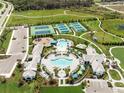 Resort-style community pool, tennis courts, playground, and clubhouse at 2803 Butterfly Jasmine Trl, Sarasota, FL 34240