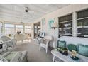 Bright sunroom with wicker furniture, perfect for relaxing at 3410 Spanish Oak Ter, Sarasota, FL 34237