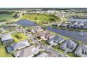Aerial view of a luxury community with lakefront properties at 1217 Blue Shell Loop, Sarasota, FL 34240