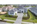 Aerial view of a luxury home with a large driveway and landscaping at 1217 Blue Shell Loop, Sarasota, FL 34240