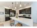 Modern kitchen with dark cabinetry, quartz countertops, and island at 12105 Goldenrod Ave, Bradenton, FL 34212