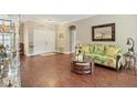 Living room with hardwood floors and floral sofa at 3165 Stokie Ave, North Port, FL 34286
