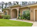 House exterior with teal door and manicured landscaping at 3165 Stokie Ave, North Port, FL 34286