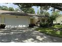 Front view of single Gathering home with attached garage and landscaping at 3925 Oakhurst Blvd # 3010, Sarasota, FL 34233