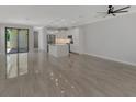 Spacious living room, open concept kitchen with island, and access to patio at 906 E Venice Ave, Venice, FL 34285