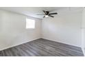 Spacious bedroom with new flooring and ceiling fan at 403 Pinewood Ave, Nokomis, FL 34275