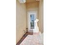 White front door with glass panels and brick walkway at 1480 Mossy Oak Dr, North Port, FL 34287
