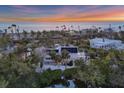 Aerial view of a coastal home, showcasing a private beachfront property at sunset at 7665 Sanderling Rd, Sarasota, FL 34242