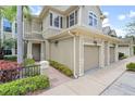 Townhome exterior showcasing walkway, landscaping, and two-car garage at 7922 Tybee Ct, University Park, FL 34201