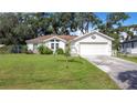 Cute one-story home with a large yard and attached garage at 2843 Abbotsford St, North Port, FL 34287