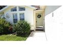 Inviting front entry with a light green door and wreath at 2843 Abbotsford St, North Port, FL 34287