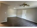Bright living room with gray flooring, a ceiling fan, and neutral walls at 4025 Crockers Lake Blvd # 11, Sarasota, FL 34238