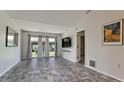 Bright living room with gray flooring and access to a patio at 2704 60Th Avenue S Plz # 2704, Bradenton, FL 34207