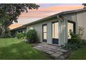 Rear exterior of condo showcasing sliding glass doors and patio at 2708 60Th Avenue W Ter # A, Bradenton, FL 34207
