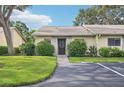 Front exterior view of condo with parking and landscaping at 2708 60Th Avenue W Ter # A, Bradenton, FL 34207