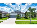 One-story house with gray garage and landscaped yard at 11721 Brighton Knoll Loop, Riverview, FL 33579