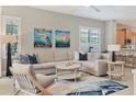 Spacious living room featuring comfortable sectional sofa and coastal art at 7349 Wexford Ct, Lakewood Ranch, FL 34202