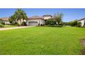 One-story home with gray garage door and manicured lawn at 4803 Cabreo Ct, Bradenton, FL 34211