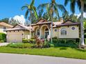 Stunning home with palm trees and lush landscaping at 12313 Baypointe Ter, Cortez, FL 34215