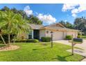 Well-maintained single-story home with lush landscaping and a two-car garage at 3541 Wilkinson Woods Dr # 40, Sarasota, FL 34231
