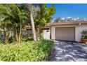 Well-maintained one-story home with a light exterior, concrete driveway and manicured landscaping at 3601 Quail Hollow Ln, Bradenton, FL 34210