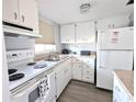 Bright kitchen featuring white cabinets and a full suite of appliances at 5933 17Th W St # A24, Bradenton, FL 34207