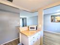 Efficient kitchen with white cabinetry and modern appliances at 5933 17Th W St # A24, Bradenton, FL 34207