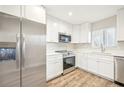 Modern kitchen featuring stainless steel appliances and white cabinetry at 3777 Lake Bayshore Dr # H401, Bradenton, FL 34205