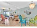 Bright dining area with colorful chairs and glass table at 2014 Canal Dr # M6, Bradenton, FL 34207