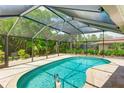 Inviting kidney-shaped pool with a covered patio at 1906 Hillsdale Pl, Sarasota, FL 34231