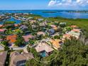 Aerial view of single Gathering home with pool in residential neighborhood at 12313 Baypointe Ter, Cortez, FL 34215