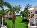 Lush lawn, palm trees, and ocean view at 4725 Gulf Of Mexico Dr # 310, Longboat Key, FL 34228