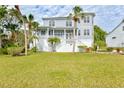 Beautiful two-story house with a large yard and palm trees at 3811 Bayside Cir, Bradenton, FL 34210
