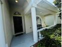 Covered front porch with a bench and decorative columns at 1822 Raven Glen Dr, Ruskin, FL 33570