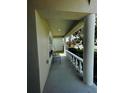 Covered front porch with a bench and decorative columns at 1822 Raven Glen Dr, Ruskin, FL 33570