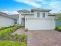Two-story home with a two car garage and landscaped front yard at 5827 Mezzana Run, Palmetto, FL 34221