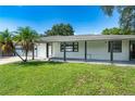 Home with a covered porch and large front yard at 2491 Hawthorne St, Sarasota, FL 34239