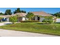 Single-story home with a two-car garage and well-manicured lawn at 10268 Alexandria Ave, Englewood, FL 34224