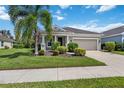Single-story house with a two-car garage and palm trees at 164 Avens Dr, Nokomis, FL 34275