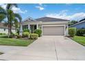 Single-story home with attached garage and landscaped front yard at 164 Avens Dr, Nokomis, FL 34275