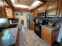 Spacious kitchen with dark wood cabinets and granite countertops at 2631 Fiesta Dr, Venice, FL 34293