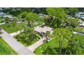 Aerial view of a home nestled among tall trees at 2631 Fiesta Dr, Venice, FL 34293