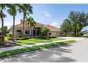 House with tile roof, lush landscaping, and driveway at 15016 Bowfin Ter, Lakewood Ranch, FL 34202