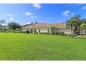 House exterior showcasing a large yard and tile roof at 5107 Whispering Oaks Dr, North Port, FL 34287