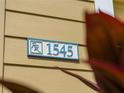 Custom house number plaque on a light yellow house at 1545 Westover Ave, Parrish, FL 34219