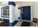 Navy blue front door accented with white trim and a welcome sign at 4907 21St E Way, Bradenton, FL 34203