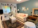 Living room features a light beige couch, green recliner, and decorative accents at 5850 Welcome Rd # J6, Bradenton, FL 34207