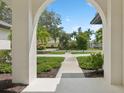 Bright entryway with arched walkway and view of neighborhood at 3973 Boca Pointe Dr, Sarasota, FL 34238